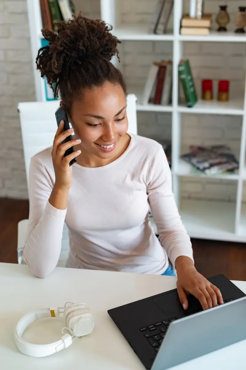 Woman smiling while working on her laptop